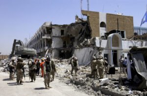 Rescue workers and US Military soldiers search through rubble and debris at the United Nations (UN) Office of Humanitarian Coordinator Building in Baghdad, Iraq, after a truck bombing destroyed much of the building during Operation IRAQI FREEDOM.